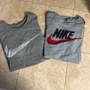 2 Nike t-shirts with the Nike swoosh on the front